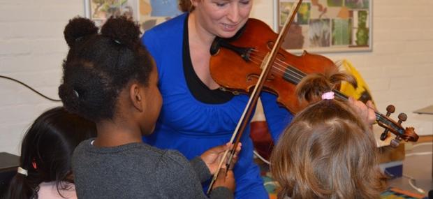Gabriella spiller violin med en gruppe børn